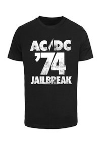 Sort bomulds T-shirt med fed, slidte hvide tekst, der står "AC/DC '74 JAILBREAK" med en lyn-accent.