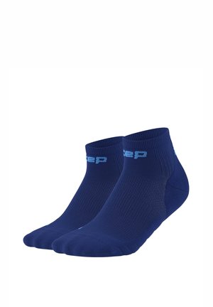 Pair of navy blue ankle socks with light blue text logo on cuff, ribbed texture, and reinforced heel and toe areas.