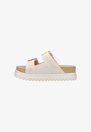 White slide sandals with two textured straps featuring the brand name. Rubber sole with a slight heel, offering a comfortable design.