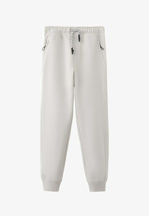 Hellgraue Jogginghose mit elastischem Bund, schwarzem und weißem Kordelzug, Seitentaschen und gerippten Bündchen.
