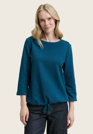 Teal langarm shirt met een ronde halslijn, met manchetten op de mouwen en een trekkoord in de onderkant, met knoopaccenten op een schouder.
