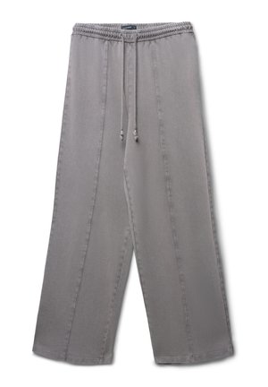 Pantalons large gris en tissu doux, dotés d'une taille élastique avec cordon de serrage et de coutures verticales de chaque côté.