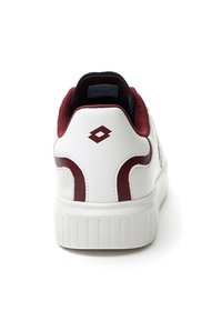 White sneaker with maroon accents, leather and mesh upper, padded collar, textured sole, and a logo on the heel. Rounded toe design.