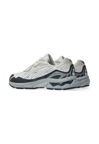 Pair of white and gray Asics running shoes with mesh and suede panels, thick soles, and black outsole details on a white background.