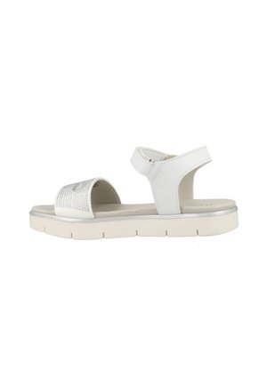 White sandal featuring a textured strap, adjustable ankle strap, and a white rubber sole with a silver accent. Open-toe design.