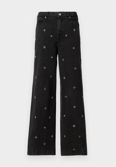 Black wide-leg jeans made of denim featuring intricate silver beading and embroidery in floral and geometric patterns throughout.