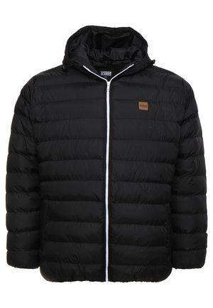 Zwarte opblaasjack met ritssluiting, gewatteerd ontwerp en een capuchon. Voorzien van een klein bruin logopatch en een contrasterende witte rits.