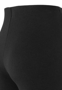 Black high-waisted leggings made from a stretchy fabric. Smooth texture with no visible patterns or hardware details.