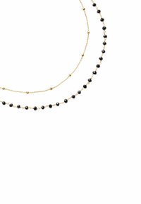Naszyjnik w odcieniu złota składający się z dwóch warstw. Jedna warstwa ma złote koraliki, podczas gdy druga ma na przemian czarne koraliki i złote akcenty.