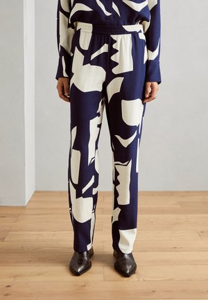 Marineblauwe broek met grote witte abstracte patronen, gemaakt van gladde stof, met een elastische tailleband en een rechte pijpdesign.