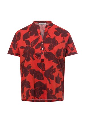 Red short-sleeve shirt featuring a black leaf pattern, a henley neckline with buttons, and a slightly relaxed fit. Soft fabric texture.