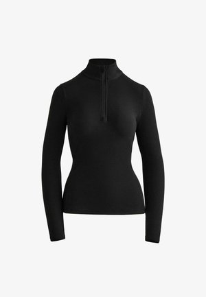 Zwarte lange mouwen top met een hoge kraag en een rits bij de hals. Gemaakt van een soepele, rekbare stof en heeft een getailleerde pasvorm.