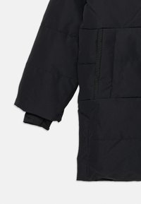 Black puffer jacket featuring a quilted design, wide sleeves, and a high collar. Includes a black side pocket and elastic cuffs.