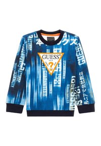 Felpa blu a maniche lunghe con un mix di testi e motivi, inclusa una prominente logo triangolare arancione con "GUESS" al centro.