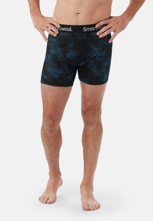 Herrers boxer briefs i ett mörkblått och svart abstrakt mönster, tillverkade av elastiskt material, med en bred svart midja med "Smartwool"-logotyp.