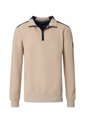 Beige pullover met een ritskraag, voorzien van marineblauwe accenten op de kraag en schouders. Geribbelde textuur, lange mouwen en aansluitende manchetten.