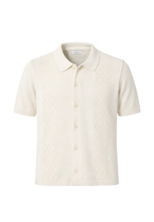 Polo in maglia color crema a maniche corte con chiusura frontale a bottoni e pannelli con motivo a diamante sottile su entrambi i lati.