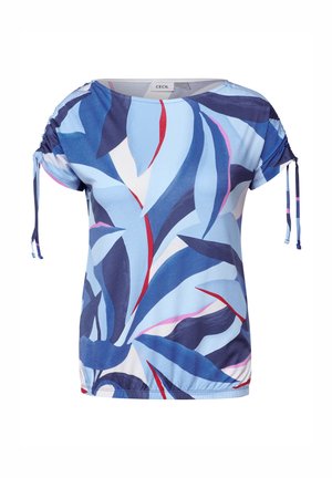 Haut à manches courtes bleu clair, avec un motif de feuilles en bleu foncé, blanc et rouge. Les liens ajustables sur les côtés créent un effet froncé.