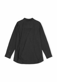 Maglietta nera a maniche lunghe realizzata in un tessuto leggero con un design unico sul retro, caratterizzato da un pannello sovrapposto e polsini con bottoni.
