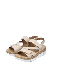 Beiga sandaler med korsade remmar, tillverkade av mjukt läder. Kork- och vit gummisula med en lätt kil för upphöjning och grepp.