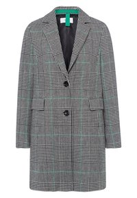 Cappotto a scacchi con motivo houndstooth bianco e nero e dettagli verde, con rever a punte, due bottoni e tasche laterali.