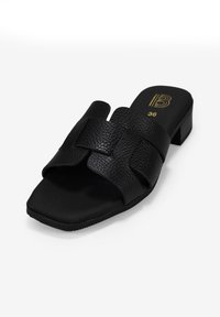Sandalia deslizante de cuero negro con un acabado texturizado, que presenta dos correas anchas y un tacón bajo de forma cuadrada. Talla 36.