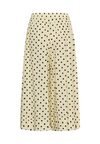Pantalon crème à jambes larges avec pois noirs, taille élastique et coupe ample et fluide.