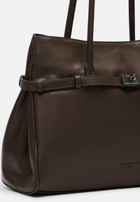 Ciemnobrązowa skórzana torebka z dwoma uchwytami, wąskim paskiem z srebrną klamrą z przodu oraz subtelnym tłoczeniem logo poniżej.
