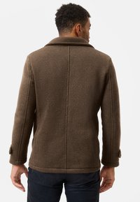 Brown textured coat with a collar, buttoned cuffs, and a straight cut. Material shows a subtle herringbone pattern.