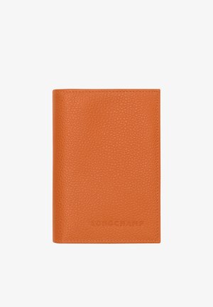 Orange textured leather wallet with visible stitching and embossed "Longchamp" branding on the lower front center.