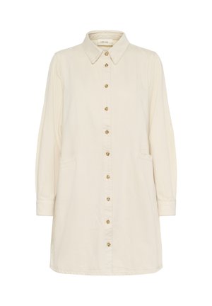Kreemivärviline nööpide külge kinnitatav kleit, millel on krae, pikad varrukad, ees taskud ja sirge siluett, kuldse tooni nööpidega.