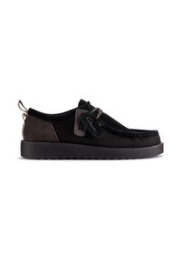 Black and brown slip-on shoes with a mesh upper, suede accents, and a textured rubber sole; features a decorative pull tab and label.