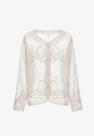 Transparante crèmekleurige kanten blouse met vlinderborduursel, geschulpte randen en knoopsluiting aan de voorkant.