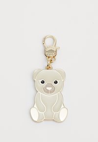 Porte-clés en forme d'ours en ton or, avec un corps gris lisse, des yeux noirs et un mousqueton pour fixation. Présente une finition brillante.