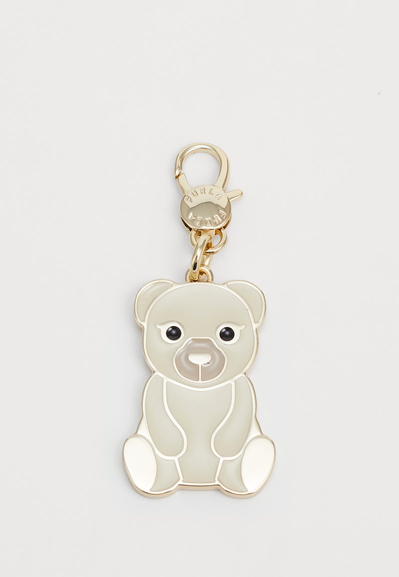 Porte-clés en forme d'ours en ton or, avec un corps gris lisse, des yeux noirs et un mousqueton pour fixation. Présente une finition brillante.