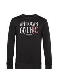 Felpa nera a maniche lunghe in cotone, con la scritta "AMERICAN GOTHIC" accompagnata da una 'X' rossa e "WEDNESDAY" in un carattere stilizzato.