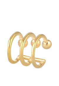Boucles d'oreilles en métal doré à trois anneaux avec une finition lisse et brillante. Chaque anneau présente une extrémité arrondie, créant un design minimaliste et moderne.