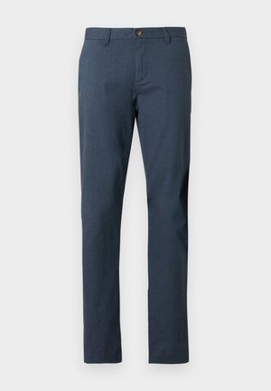 Pantalon bleu marine pour homme coupe ajustée, avec fermeture par bouton et passants pour ceinture, fabriqué en tissu texturé.