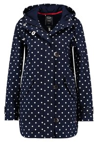 Marinblå regnrock med vita prickar, huva, knäppning fram och fickor. Tillverkad av vattentätt material med justerbara dragsnören.