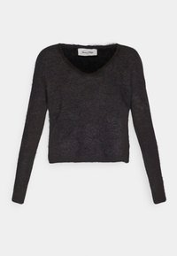 Svart kortärmad tröja med långa ärmar, V-ringning och en mjuk, texturerad yta. Utsmyckad med en subtil, fluffig framtoning.