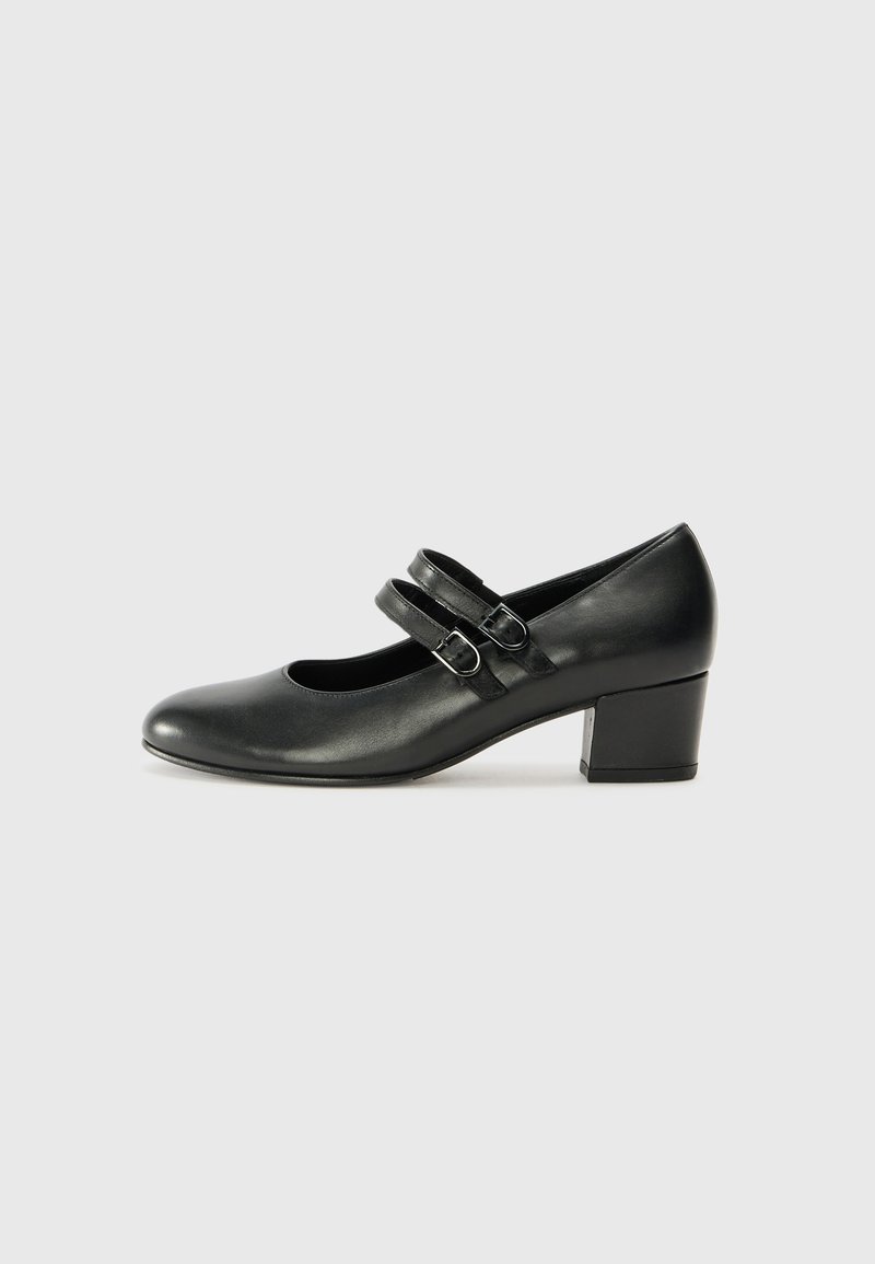 Black leather Mary Jane shoe featuring a rounded toe, two adjustable buckled straps, and a sturdy block heel. Smooth texture with a polished finish.