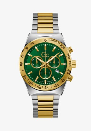 Kronograafi kell rohelise diali, kuld- ja hõbedase roostevabast terasest korpuse ja rihmaga. Omab kuldseid aktsente, taksiometrit ja kuupäeva näidikut.