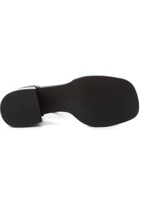 Black leather shoe outsole with a smooth, solid structure and textured grip pattern. Features a square heel for stability.