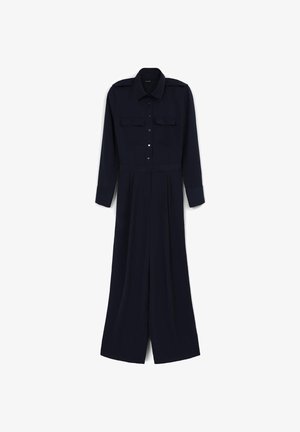 Navyblauer Overall mit langen Ärmeln, Knopfverschluss, zwei Brusttaschen und weitem Bein. Hergestellt aus einem glatten, leichten Stoff.