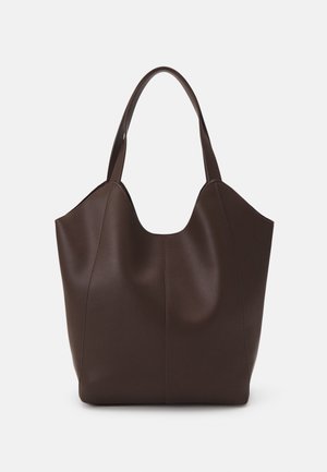 Brown leather tote bag with a sculptural design, featuring two handles, smooth texture, and seam detailing along the sides.