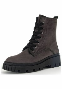 Black leather ankle boot with a chunky black sole, round toe, and front lace-up closure. Features metal eyelets and textured surface.