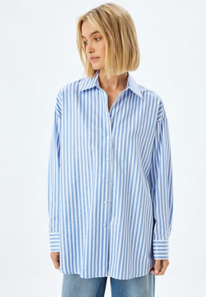 Blue and white striped oversized shirt, made of lightweight fabric, featuring a button-down front and wide cuffs.