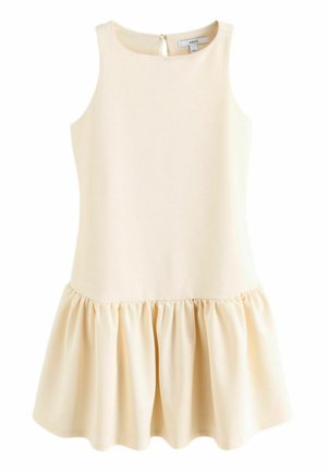 Robe sans manches de couleur beige pâle avec un décolleté rond, présentant une jupe évasée plissée et une fermeture dos en forme de trou de serrure. Texture de tissu lisse.