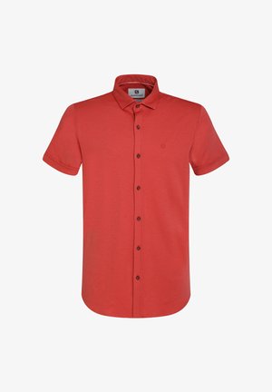 Rdeča polo majica s kratkimi rokavi iz mehkega blaga, z gumbom na sprednji strani, klasičnim ovratnikom in majhnim logotipom na levem prsnem delu.