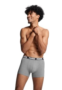 Gray boxer briefs made of cotton with a black elastic waistband featuring the white "PUMA" logo. Smooth texture and form-fitting design.